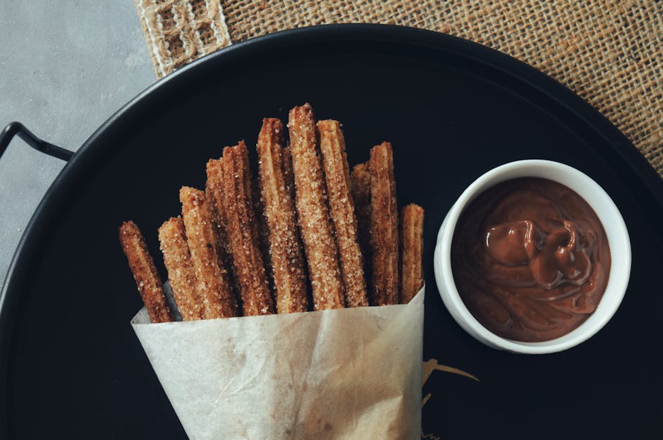 Churrerías Madrid chocolate churros — tray of churros with chocolate sauce